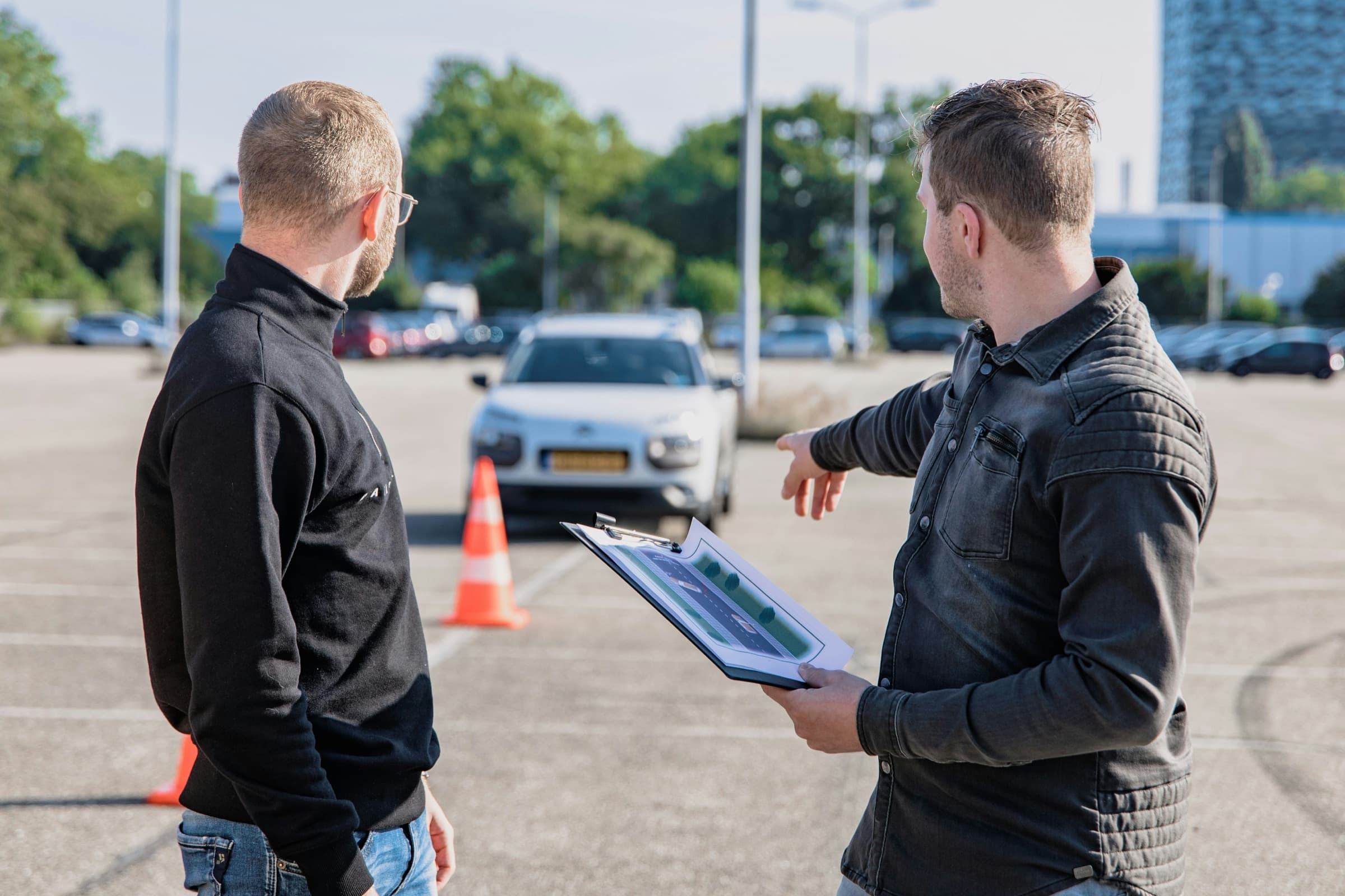 An instructor explains the practical test to a candidate at a manoeuvring area